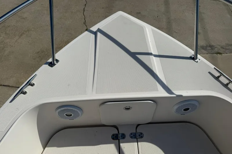 Slide: The Image of 1994 Pursuit 2150 Dual Console boat deck with speakers and storage compartment. - 31