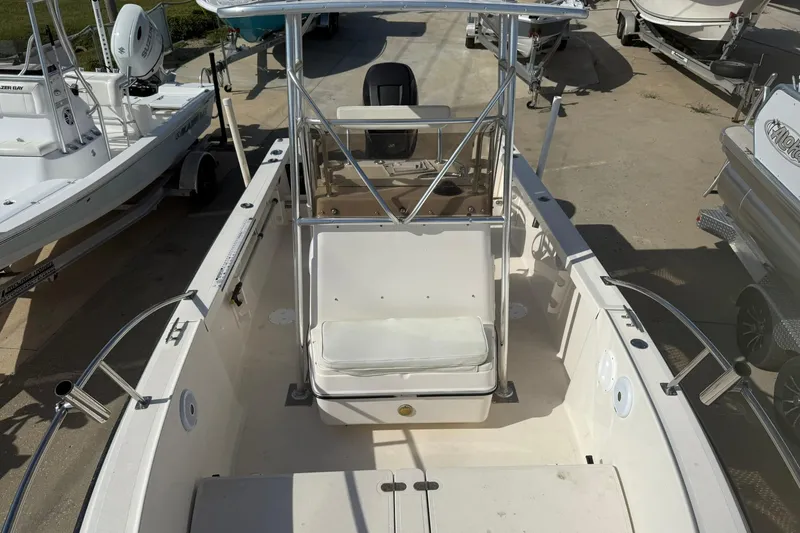 Slide: The Image of 1994 Pursuit 2150 Dual Console boat, white interior, docked among other boats. - 32
