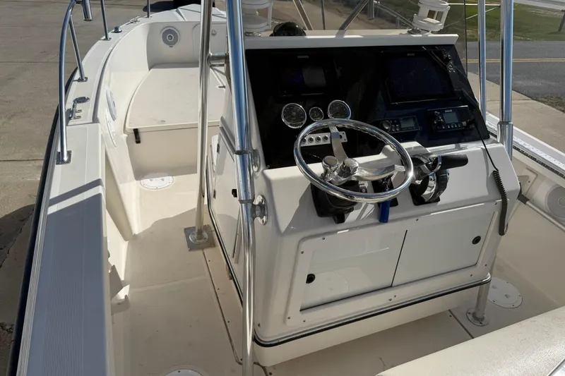 Slide: The Image of 1994 Pursuit 2150 Dual Console boat interior with steering wheel and control panel. - 33