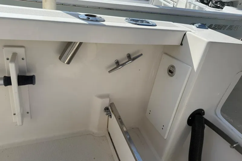 Slide: The Image of 1994 Pursuit 2150 Dual Console boat interior with rod holder and storage compartment. - 40