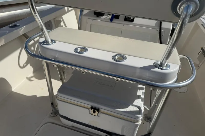 Slide: The Image of 1994 Pursuit 2150 Dual Console boat interior with cooler and rod holders. - 42