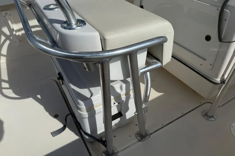 Slide: The Image of 1994 Pursuit 2150 Dual Console boat interior with cushioned seat and metal frame. - 44