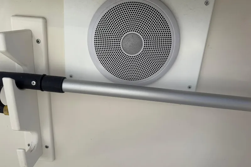 Slide: The Image of 1994 Pursuit 2150 Dual Console boat interior with speaker and metal rod. - 45