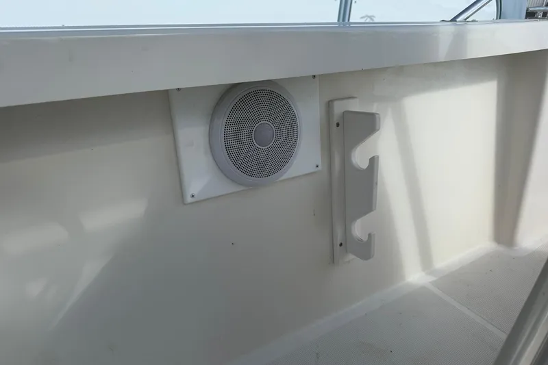 Slide: The Image of 1994 Pursuit 2150 Dual Console boat interior with speaker and rod holder. - 46