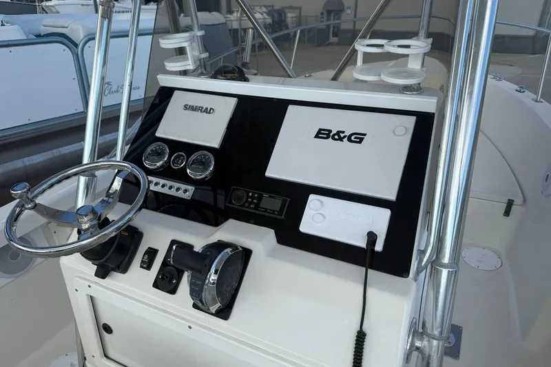 Slide: The Image of 1994 Pursuit 2150 Dual Console boat dashboard with Simrad and B&G navigation systems. - 5
