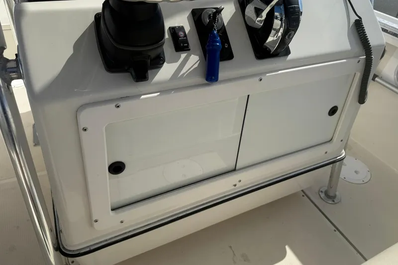 Slide: The Image of 1994 Pursuit 2150 Dual Console boat dashboard with controls and storage compartment. - 50