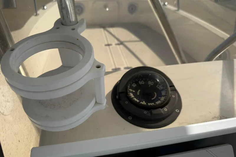 Slide: The Image of 1994 Pursuit 2150 Dual Console boat compass and holder on deck. - 51