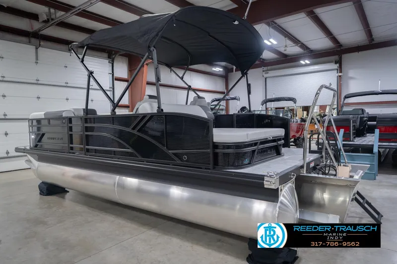 Slide: The Image of 2026 Bennington 22 SSB pontoon boat in showroom with canopy and seating. - 10