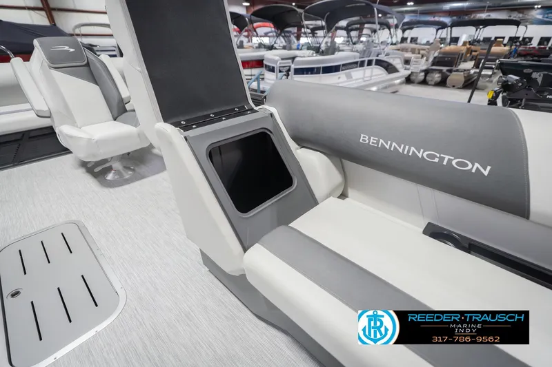 Slide: The Image of 2026 Bennington 22 SSB boat interior with storage compartment open, showcasing seating and design. - 25