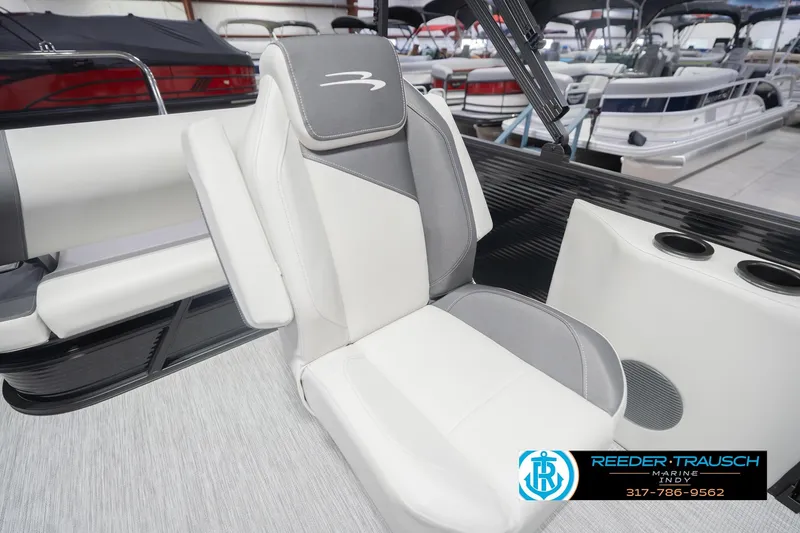 Slide: The Image of 2026 Bennington 22 SSB boat interior with white and gray seating, cup holders. - 26