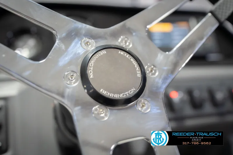 Slide: The Image of Close-up of 2026 Bennington 22 SSB steering wheel with logo, featuring sleek design. - 32