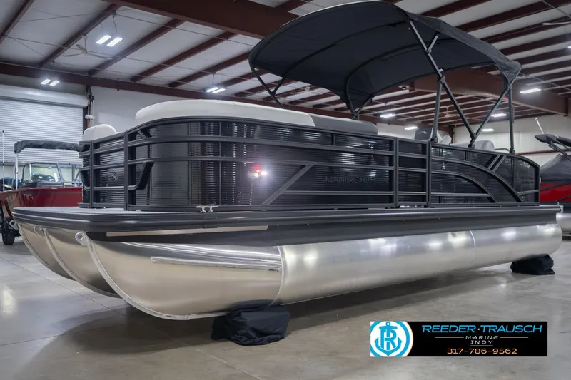 Slide: The Image of 2026 Bennington 22 SSB pontoon boat in showroom with canopy and sleek design. - 4
