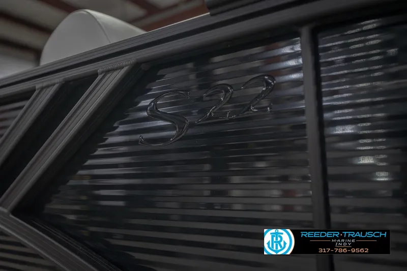 Slide: The Image of 2026 Bennington 22 SSB boat detail with S22 emblem, Reeder-Trausch Marine logo visible. - 56