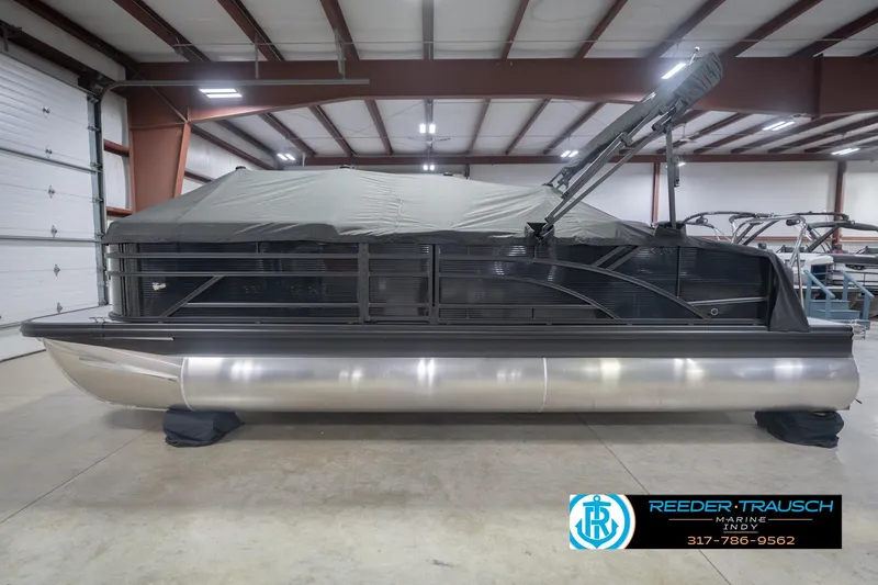 Slide: The Image of 2026 Bennington 22 SSB pontoon boat in indoor storage with cover. - 58
