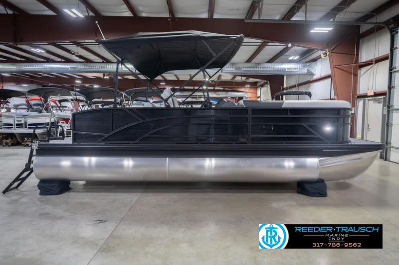 Slide: The Image of 2026 Bennington 22 SSB pontoon boat in showroom, featuring sleek design and canopy. - 7