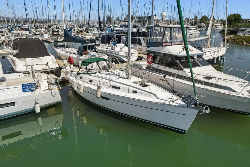 Slide: The Image of 2001 Beneteau Oceanis 361 sailboat docked in a marina, surrounded by other boats. - 1