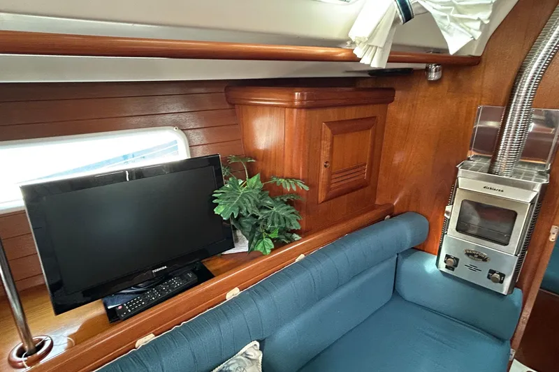 Slide: The Image of Interior of 2001 Beneteau 361 yacht with TV, plant, and stove. - 15