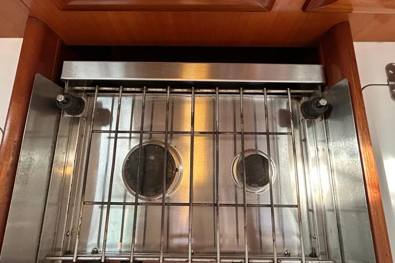 Slide: The Image of Stainless steel stove on 2001 Beneteau 361 yacht, featuring dual burners and wooden trim. - 19
