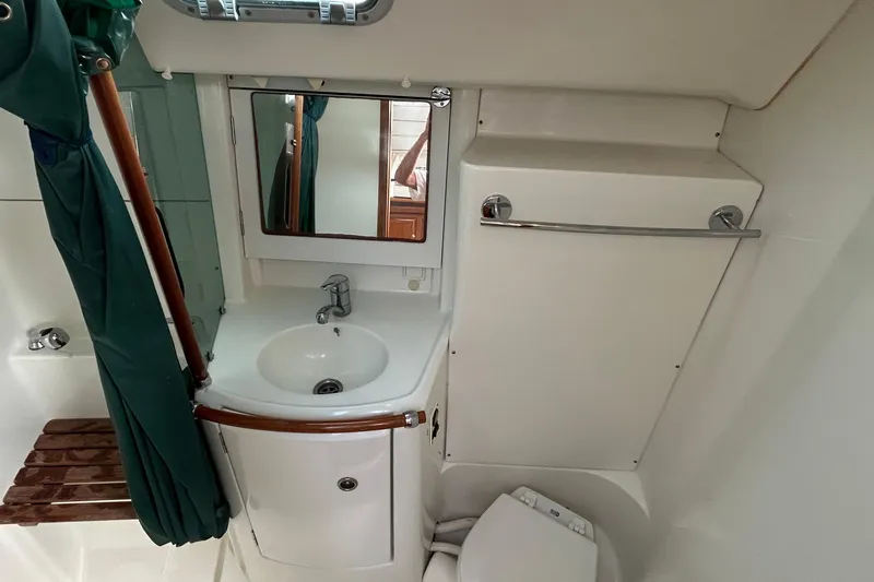Slide: The Image of Compact bathroom in 2001 Beneteau 361 sailboat with sink, mirror, and toilet. - 20