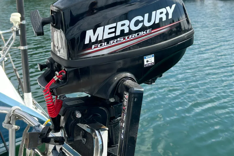 Slide: The Image of Mercury FourStroke outboard motor on 2001 Beneteau 361 sailboat, docked on calm water. - 23