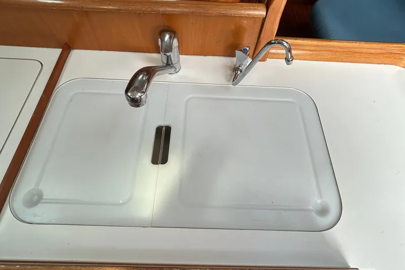 Slide: The Image of Galley sink with cover and faucet in 2001 Beneteau 361 sailboat. - 25