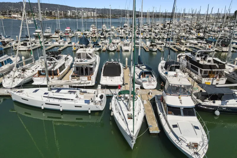 Slide: The Image of Marina filled with various boats, featuring a 2001 Beneteau Oceanis 361 sailboat. - 34