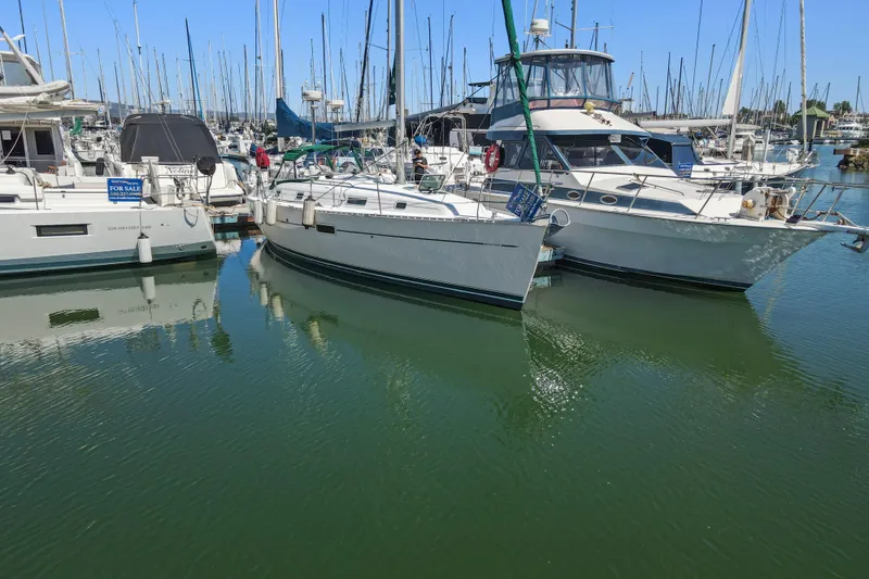 Slide: The Image of 2001 Beneteau Oceanis 361 sailboat docked in a marina, surrounded by other boats. - 35