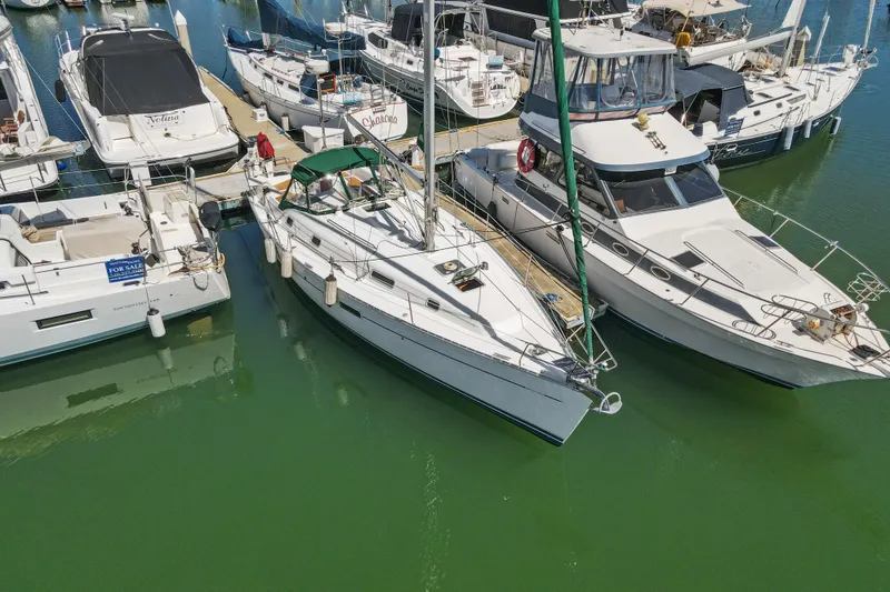 Slide: The Image of Beneteau Oceanis 361 sailboat, 2001 model, docked among other boats in a marina. - 36