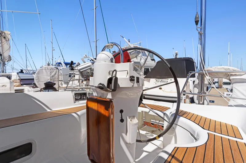 Slide: The Image of 2001 Beneteau Oceanis 361 sailboat cockpit with steering wheel and wooden deck details. - 5