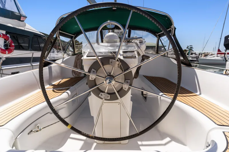 Slide: The Image of Cockpit view of 2001 Beneteau Oceanis 361 sailboat with large steering wheel and teak decking. - 6