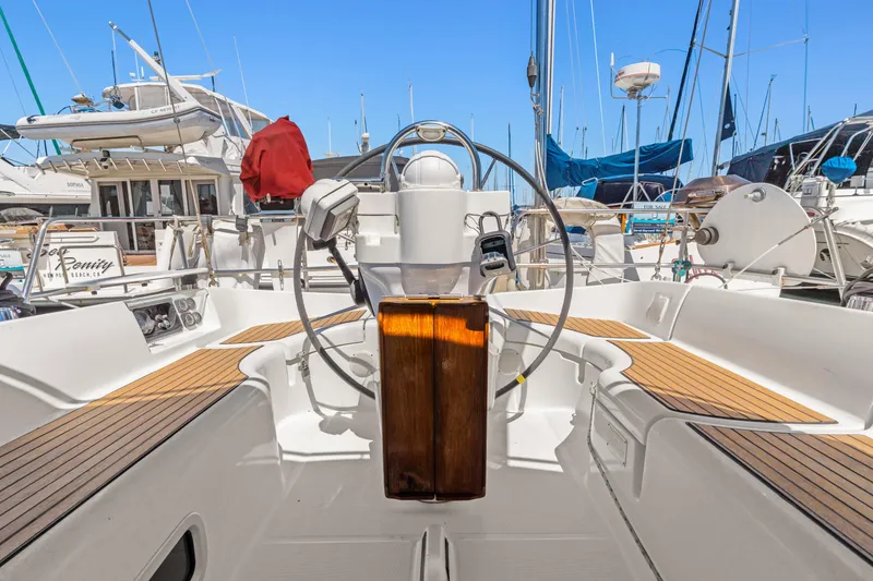 Slide: The Image of Cockpit of 2001 Beneteau Oceanis 361 sailboat with wooden accents and steering wheel. - 7