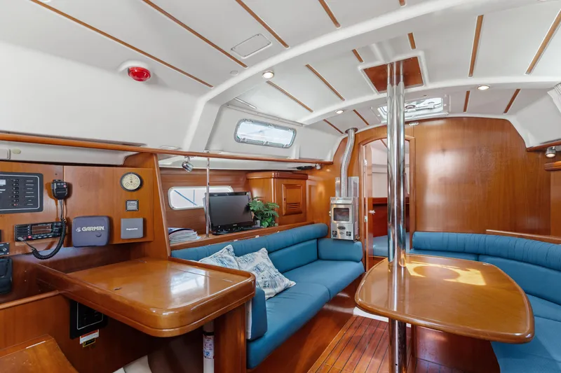 Slide: The Image of Interior of 2001 Beneteau Oceanis 361 sailboat with wood finish and blue seating. - 8