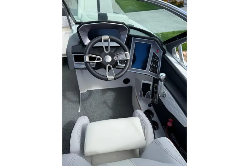 Slide: The Image of 2021 MasterCraft X24 boat cockpit with modern steering and digital controls. - 1