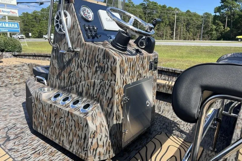 Slide: The Image of 2026 Xpress H22B Bay boat console with camouflage design and modern controls. - 12