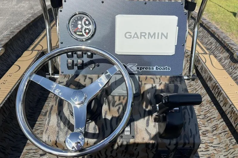Slide: The Image of Steering console of 2026 Xpress H22B Bay boat with Garmin navigation system. - 13