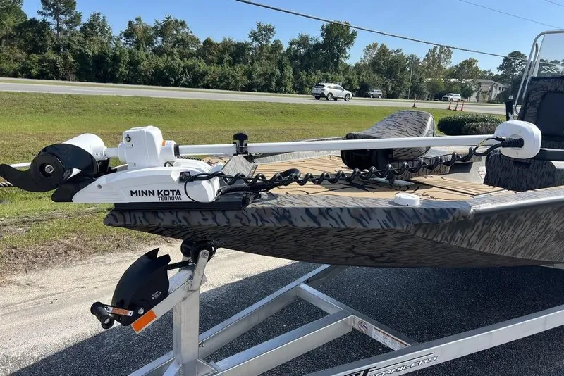Slide: The Image of 2026 Xpress H22B Bay boat with Minn Kota Terrova trolling motor on trailer. - 16