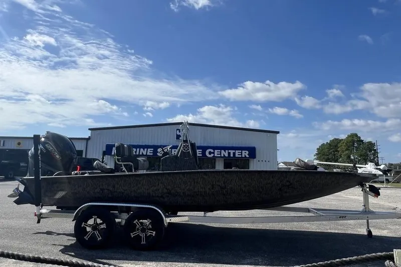 Slide: The Image of 2026 Xpress H22B Bay boat on trailer at marine service center. - 3