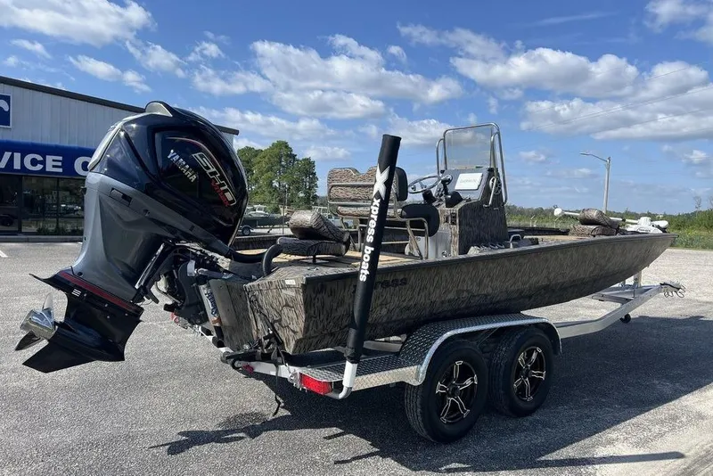 Slide: The Image of 2026 Xpress H22B Bay boat on trailer with Yamaha engine, parked outdoors. - 5