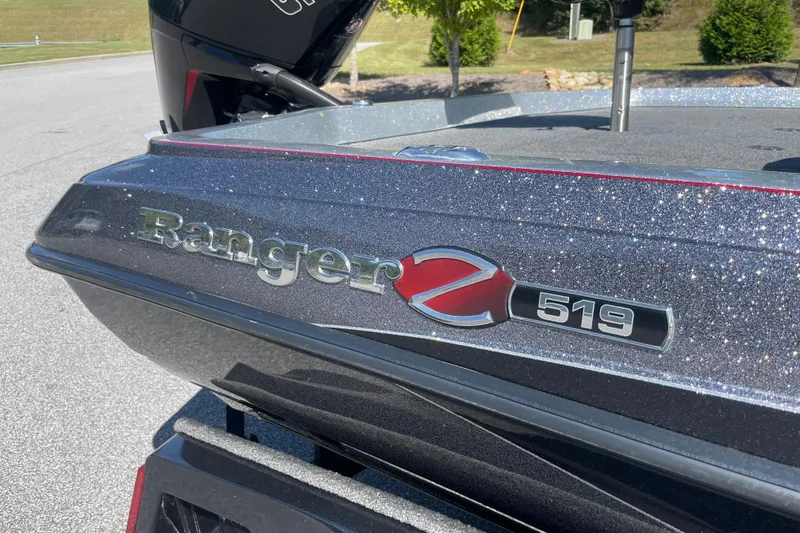 Slide: The Image of 2019 Ranger Z519 boat with glittery finish, parked outdoors. - 2