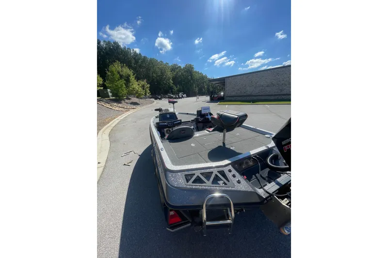 Slide: The Image of 2019 Ranger Z519 boat parked on a sunny street with clear skies. - 6
