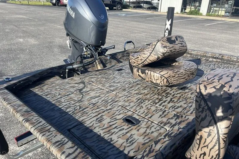 Slide: The Image of 2026 Xpress XP170 boat with camouflage seats and Yamaha motor in parking lot. - 10