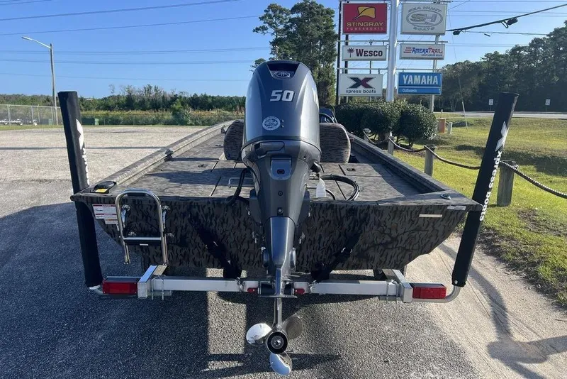 Slide: The Image of 2026 Xpress XP170 boat with Yamaha motor on trailer, outdoor dealership display. - 11