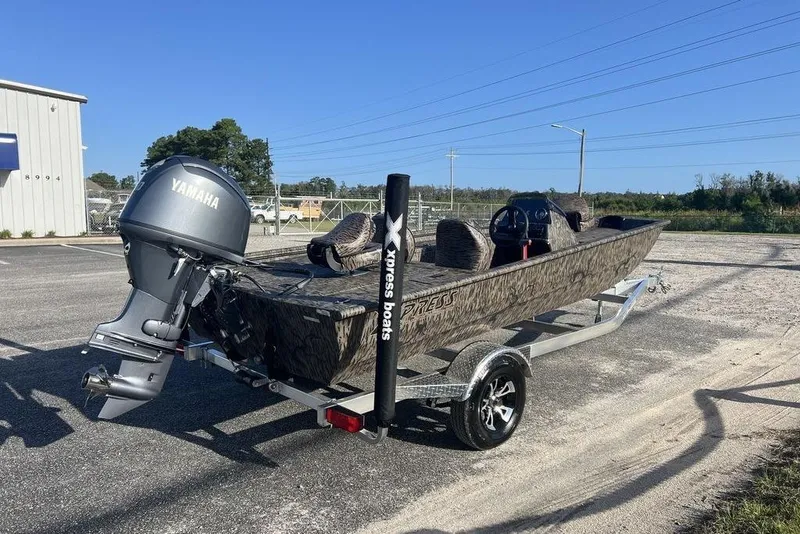 Slide: The Image of 2026 Xpress XP170 boat with Yamaha outboard motor on trailer. - 2