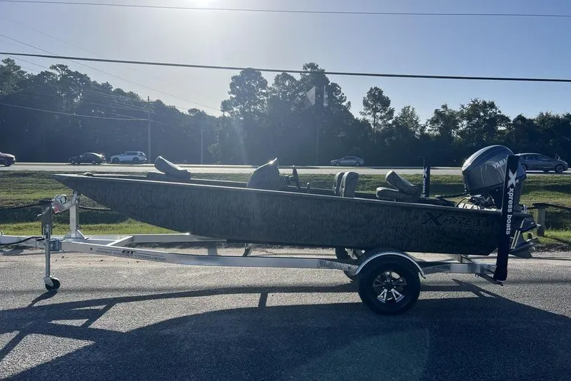 Slide: The Image of 2026 Xpress XP170 boat on trailer, parked outdoors under clear blue sky. - 5