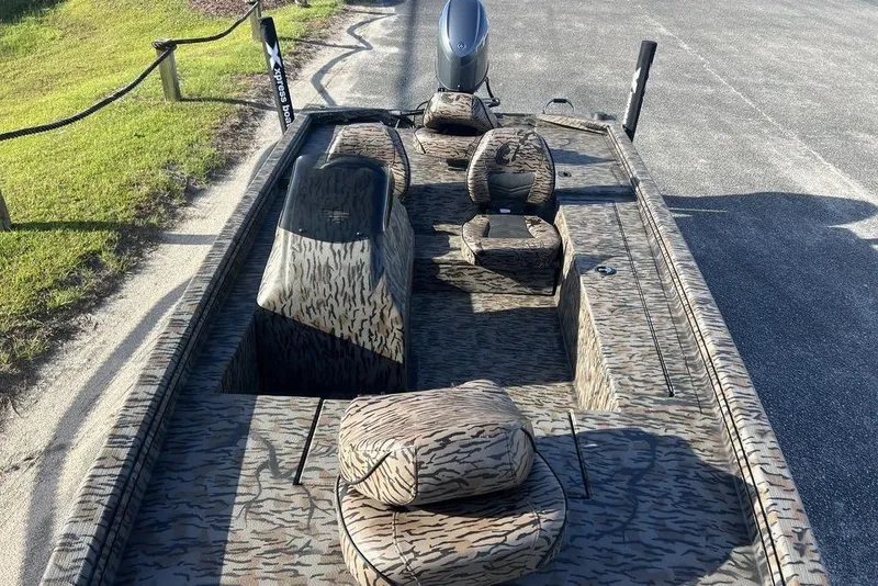 Slide: The Image of 2026 Xpress XP170 boat with camouflage interior, parked on a sunny day. - 6