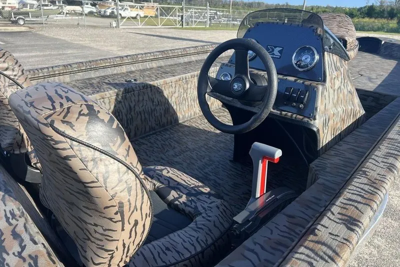 Slide: The Image of 2026 Xpress XP170 boat interior with camouflage design and steering console. - 8