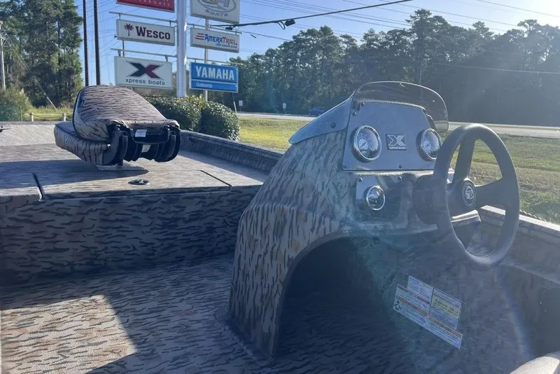 Slide: The Image of 2026 Xpress XP170 boat interior with camouflage design, steering wheel, and dashboard. - 9