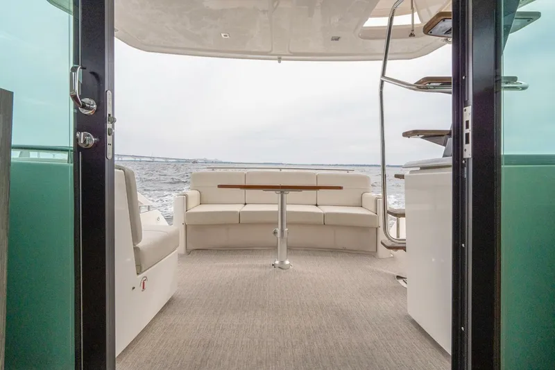 Slide: The Image of 2021 Tiara Yachts F44 Flybridge interior with seating and ocean view. - 12