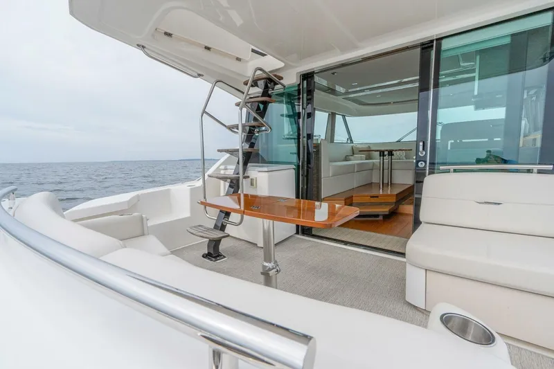 Slide: The Image of Luxurious 2021 Tiara Yachts F44 Flybridge with elegant seating and ocean view. - 15