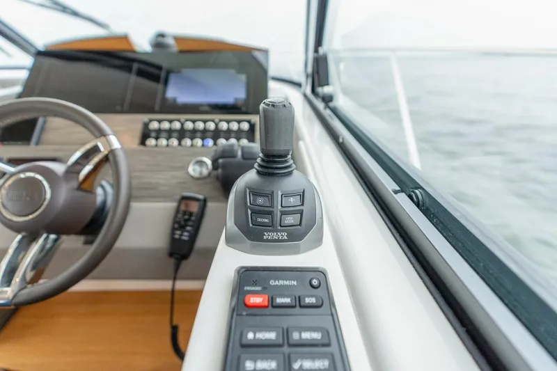 Slide: The Image of 2021 Tiara Yachts F44 Flybridge helm with joystick and control panel. - 22